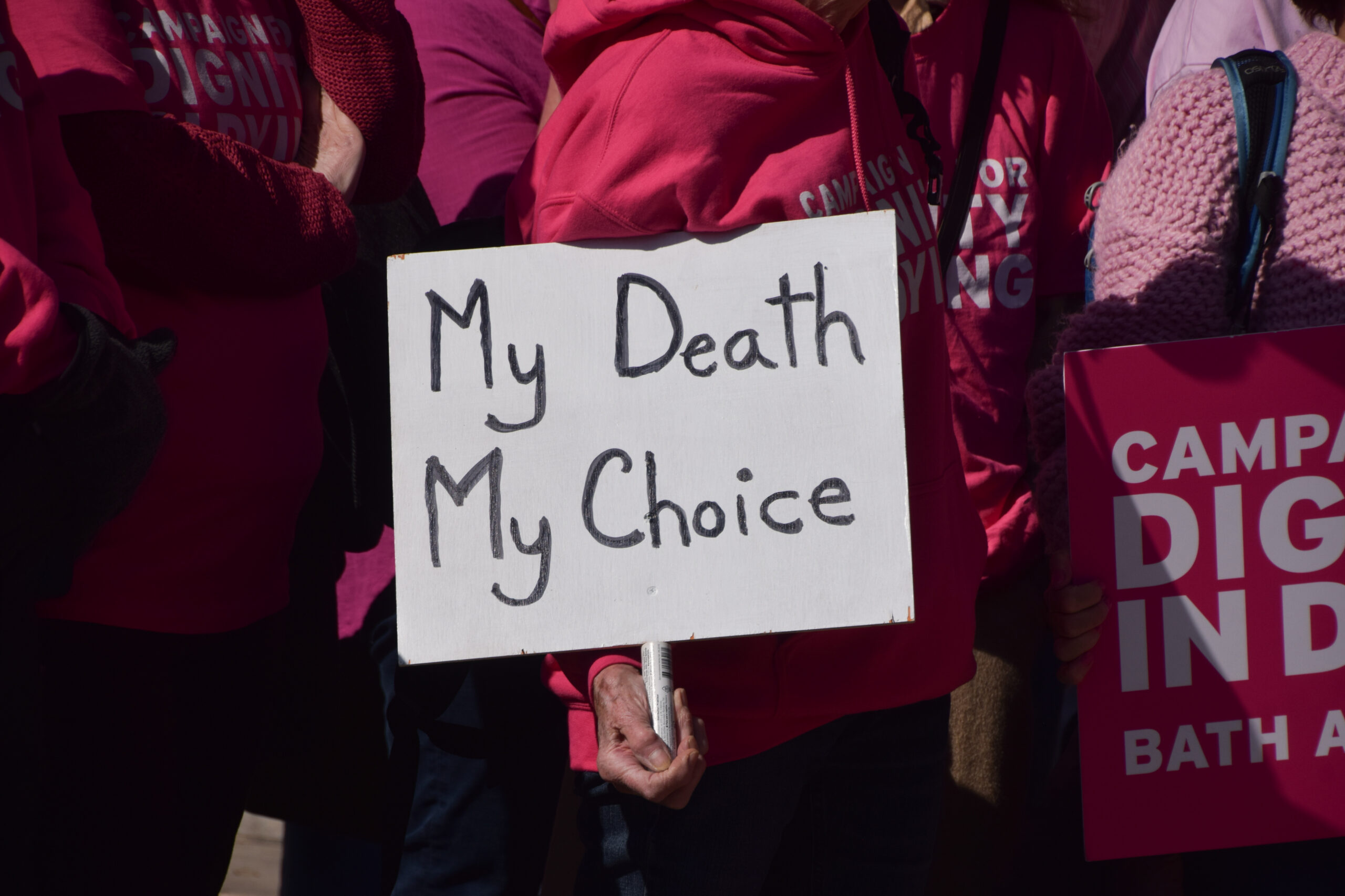 A protester holds a 'My death, my choice' placard during the