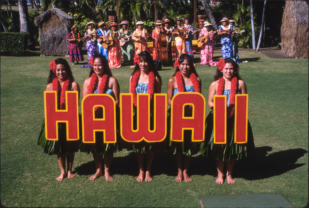 Hula Dancers Hold Up Letters Spelling Hawaii