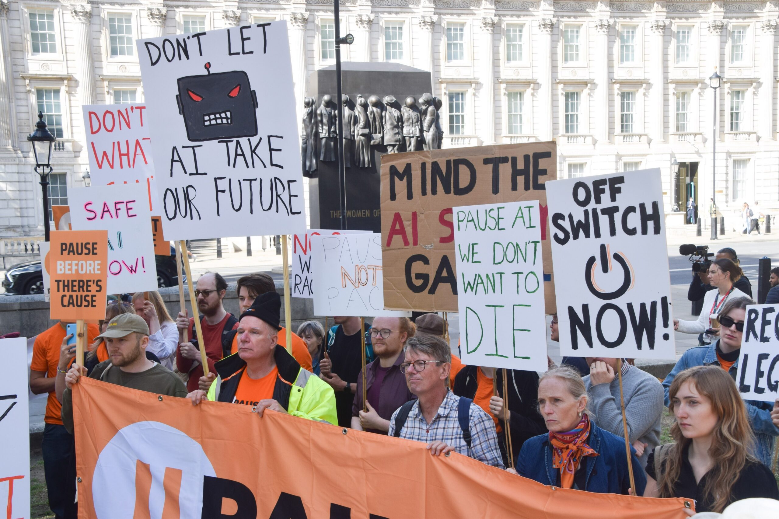 Protesters hold placards and a banner during the